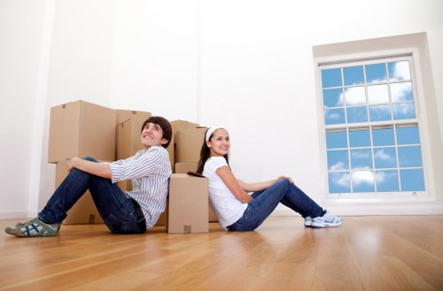 Professional movers carrying furniture through a home with careful protection