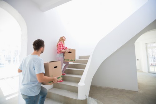 Apartment removal with items being carried through a shared entrance in Ickenham
